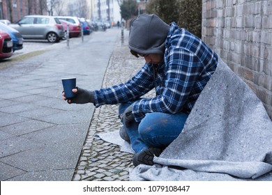 beggars-hand-wearing-gloves-holding-260nw-1079108447.jpg