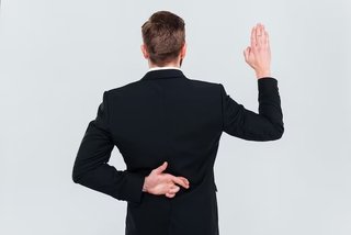 back-view-business-man-black-suit-lying-holding-hand-with-fingers-crossed-his-back-swears-isolated-g.jpg