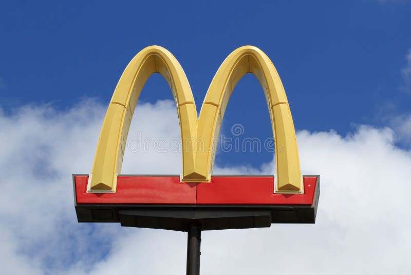 mcdonalds-golden-arches-sign-against-blue-sky-fluffy-white-clouds-31924327.jpg